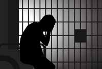 silhouette of a man in a jail cell