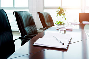 conference table with an open notebook and pen