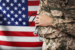 Army phsician in front of American flag