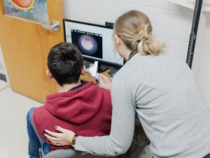 student getting an ear exam via telehealth