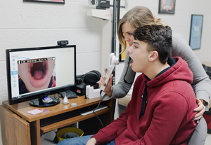 student getting throat exam via telehealth