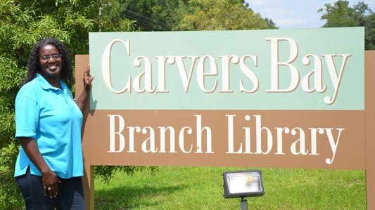 Marilynn Lance-Robb by Carvers Bay Branch Library sign