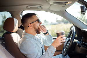 photo of a man yawning while driving