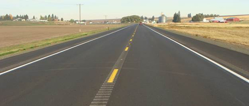 photo of a rural road with center line and shoulder rumble strips